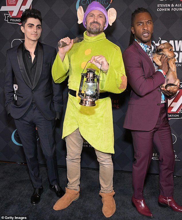 Going crazy: Brian hosted an animal rescue gala just before Halloween 2022, and he poses there with his co-host Scott Evans (right) and with Kassius (left)