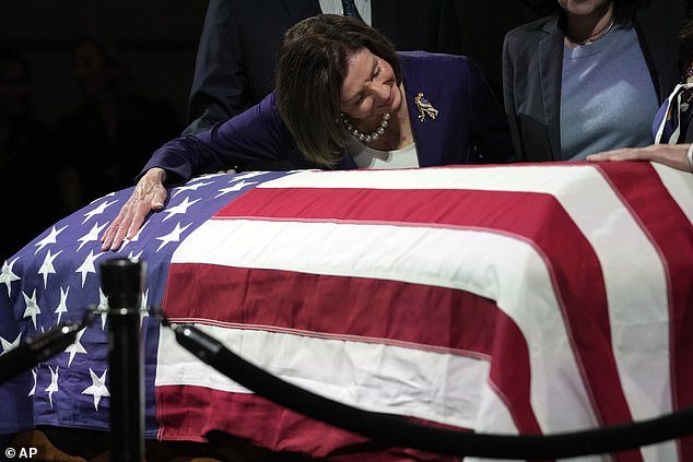 Representative Nancy Pelosi, 83, hugs Feinstein's casket as it lies in state at San Francisco City Hall