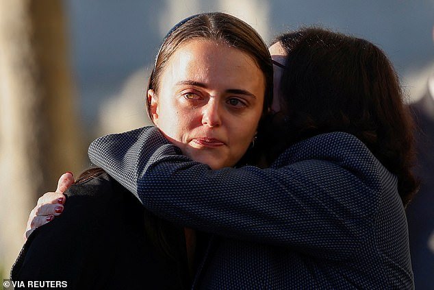 Katherine Feinstein hugs her daughter Eileen Feinstein Mariano as they mourn their mother and grandmother in San Francisco on Wednesday