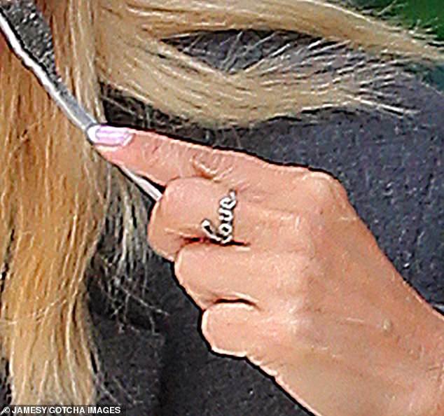 Romance: Former Eternal singer Louise wore a silver ring with the word 'love' just days after speaking out about her first new relationship since splitting from ex-husband Jamie.