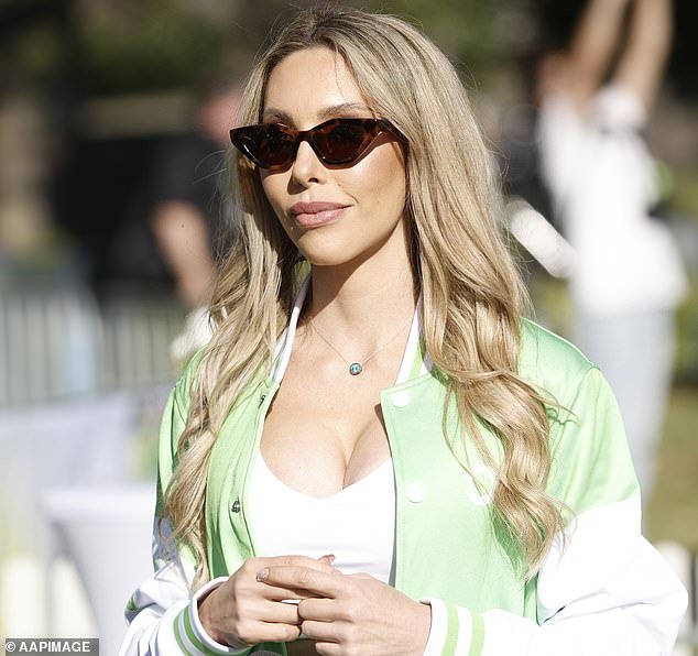 Khloe, 38, was dressed to impress in a loose white top that revealed her cleavage and stomach, paired with white leggings and a green and white varsity jacket emblazoned with the charity's logo