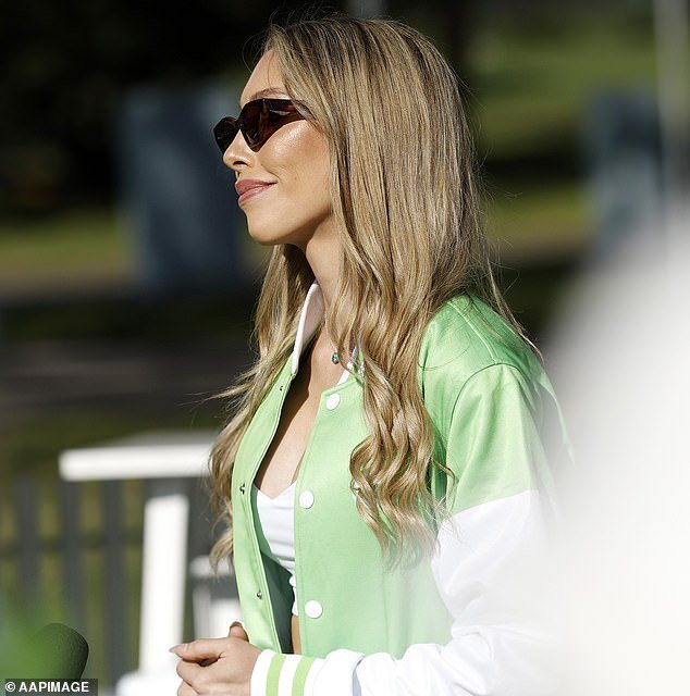 Wearing her hair down in neatly curled waves, the blonde actress completed her look with cat-eye sunglasses and a sleek green pendant necklace