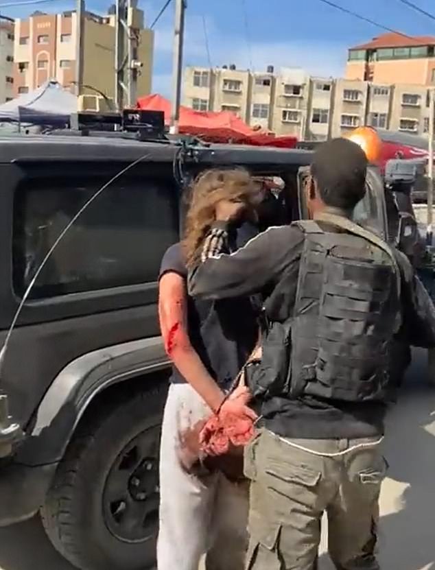 An Israeli woman is seen being forced into a car by a terrorist before being taken to the Gaza Strip