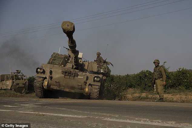 Israeli soldier drives armored vehicles heading towards the southern border with the Gaza Strip on October 8, 2023 in Sderot, Israel.  The nation is preparing a full counteroffensive against the terrorist organization, including an invasion of Gaza