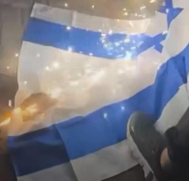 Daily Mail Australia witnessed a large crowd of men attempting to light the Israeli flag with firecrackers before they began stamping on it and tearing it to pieces (pictures)