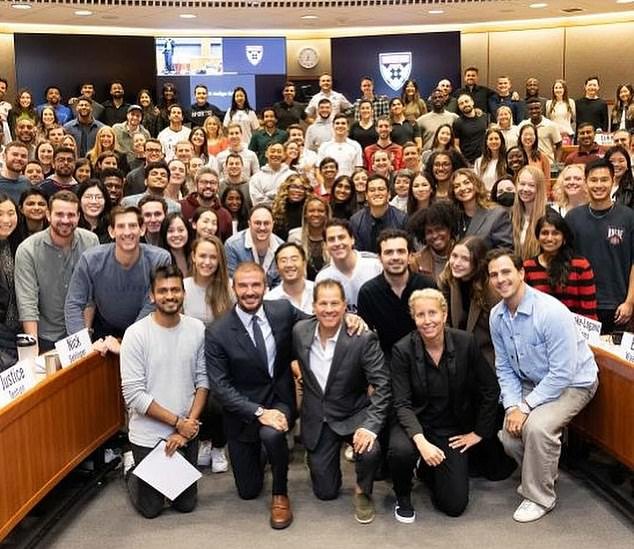Beckham poses for photos with the students he spoke to in Massachusetts