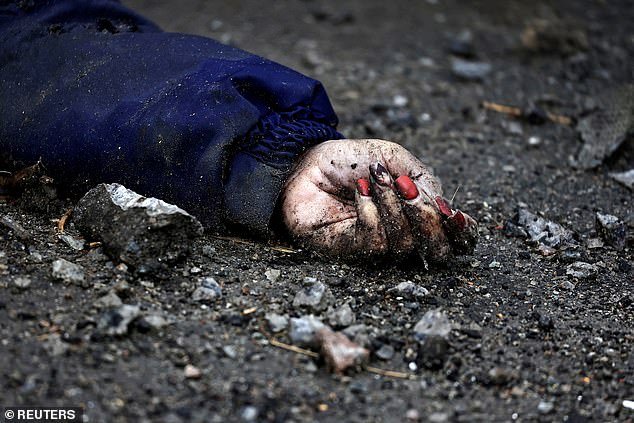 The hand of Iryna Filkina, a woman who residents say was killed by Russian army soldiers, is pictured as her body lies on the street, amid Russia's invasion of Ukraine, in Bucha, Kyiv region, Ukraine April 2, 2022