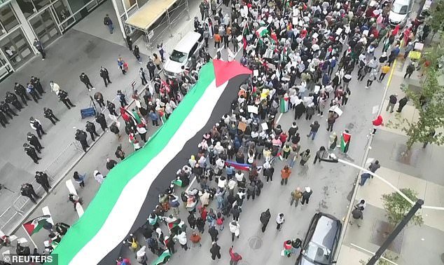 Palestinian-Americans and their supporters protest as the conflict between Israel and the Palestinian militant group Hamas continues, outside the Israeli consulate in downtown Chicago on October 8