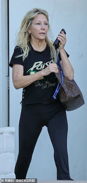 Back in black: The stunning star, 61, rocked a Poison band t-shirt, black joggers and a Louis Vuitton bag for the day outing in the tony town of Calabasas