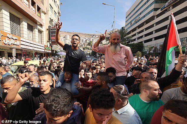 Palestinians in the West Bank city of Nablus celebrate on October 7, 2023, after terrorists from the Gaza Strip infiltrated Israel
