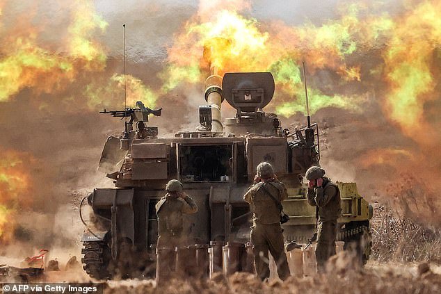 An Israeli army self-propelled howitzer fires rounds near the Gaza border in southern Israel
