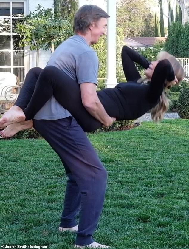She does crunches in his arms: The workout included straddling her
