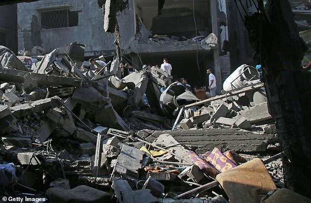Large-scale shelling in Gaza has left parts of the city completely destroyed (pictured, damage from an airstrike)