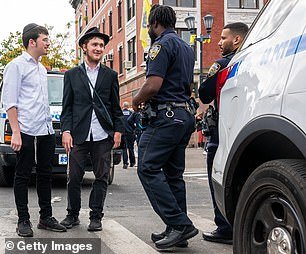Police patrol a neighborhood in Brooklyn with a large Orthodox Jewish community