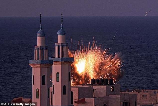 A fireball explodes from an Israeli airstrike in Gaza City on October 12