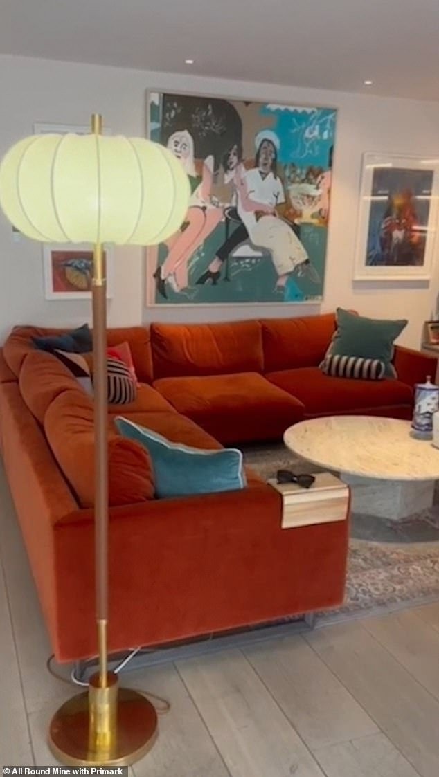 Wow: One of the three reception rooms includes a bold orange velvet sofa