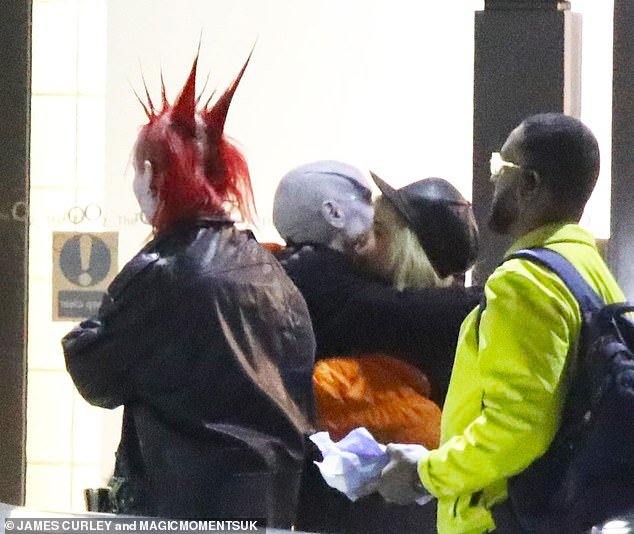 Hug: Singer Paloma cut a relaxed figure in a black and orange jacket with a black baseball cap as she shared a hug with pal