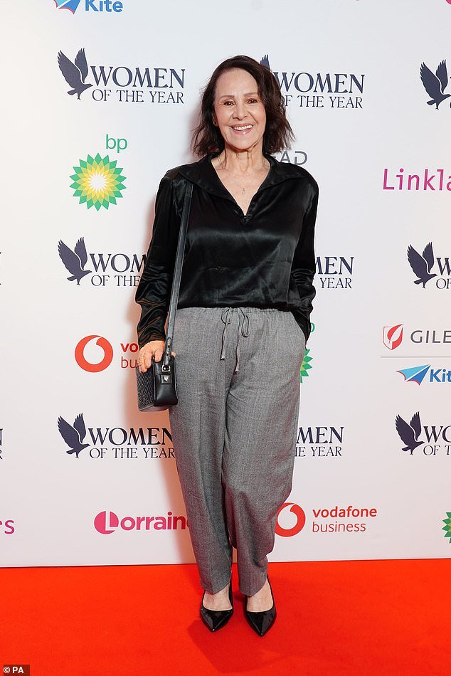 Chic: Arlene Phillips opted for a more casual look consisting of gray trousers and a black satin top