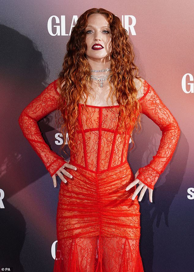 Strike a pose: Songstress Jess' outfit featured loose pleats on her skirt which lay on the ground as she posed on the red carpet separately from Alex