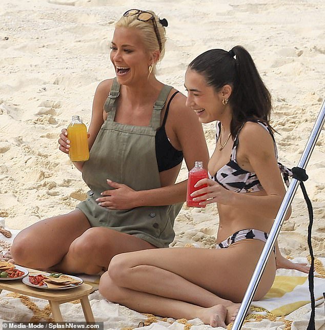 Fun: Longtime actress Olivia Bentley, 28, also sunned herself on the beach as she enjoyed a drink with pal Bella Sharpe