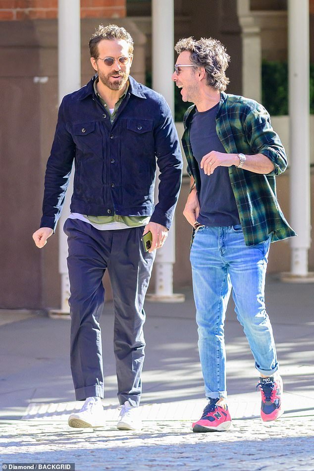 Shawn's look: The director – whose outing with Reynolds, his wife Blake Lively, Hugh Jackman and Taylor Swift sparked rumors that Swift has been cast in Deadpool 3 – opted for a dark blue t-shirt under a black and green flannel