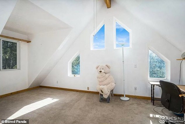 If you go to the forest today!  In a bedroom photo of a Colorado home, a rather scared-looking giant stuffed bear is seen huddled on a chair