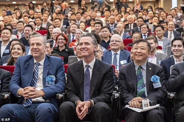 California Gov. Gavin Newsom (center) poses for a group photo with guests after a fireside chat at Hong Kong University in Hong Kong Monday.  He then travels to Beijing, Shanghai and the provinces of Guangdong and Jiangsu