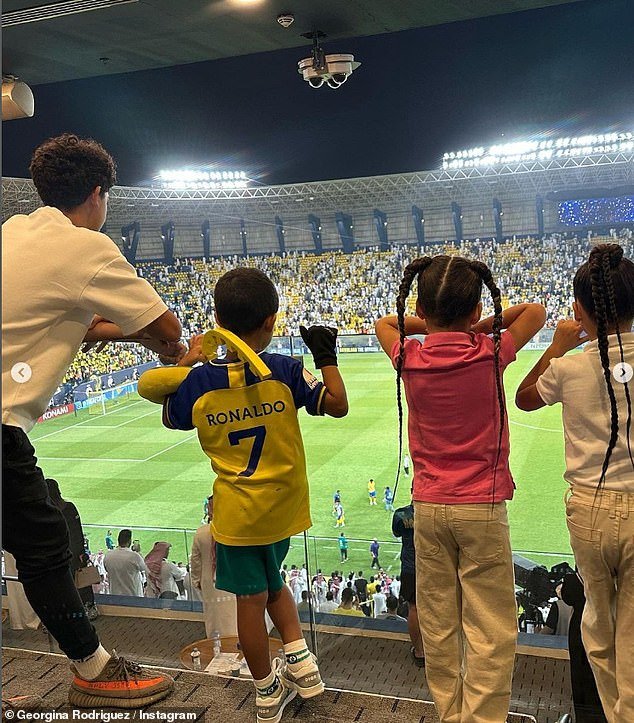 Family: The mother shared a sweet photo as the footballer's offspring watched their father's match