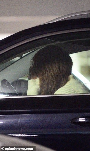 Malia walked back to her car alone, where she was pictured with her head on the steering wheel