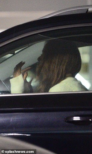 Malia walked back to her car alone, where she was pictured with her head on the steering wheel