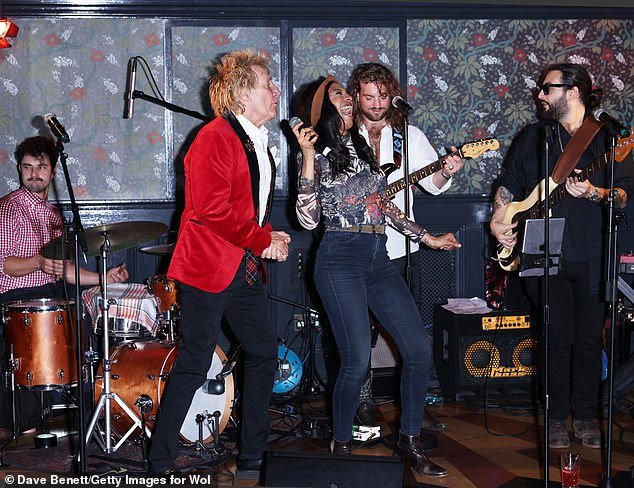 Making music: Sir Rod's band was spotted behind him as he danced around the stage at the party this week