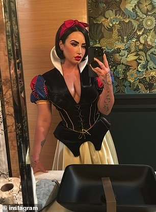 Enchanting: The 31-year-old music artist - who partied with Paris Hilton on Saturday - dressed up as a busty version of Disney character Snow White