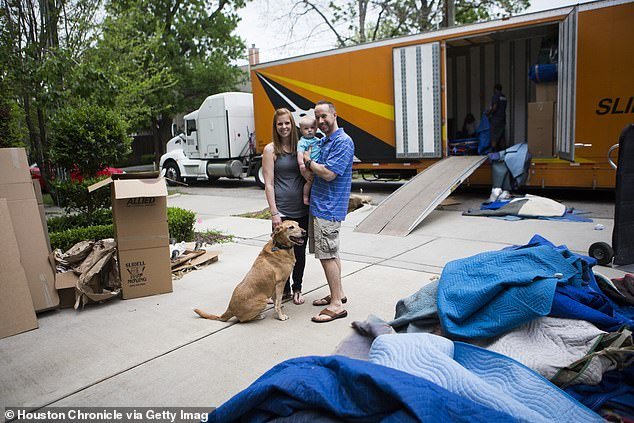 Scott Wilhide, his wife Alysia Wilhide, their nine-month-old son Jackson and their dog Levee in their new home in Houston, Texas, after leaving Pittsburgh, Pennsylvania