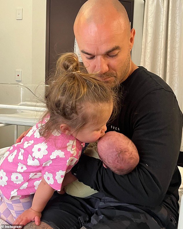 In the candid photos from the hospital, the couple's eldest daughter Cleo, two, was seen kissing baby Drew on the forehead as Tom nursed him.