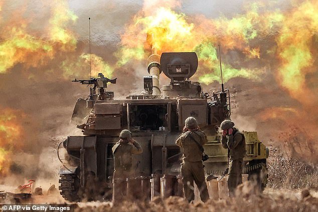 An Israeli army self-propelled howitzer fires rounds near the Gaza border in southern Israel today