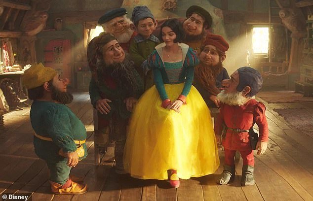 In a new publicity photo, Disney revealed live-action Snow White sitting among CGI dwarfs, who the company originally said would not be featured in the updated telling of the fairy tale.