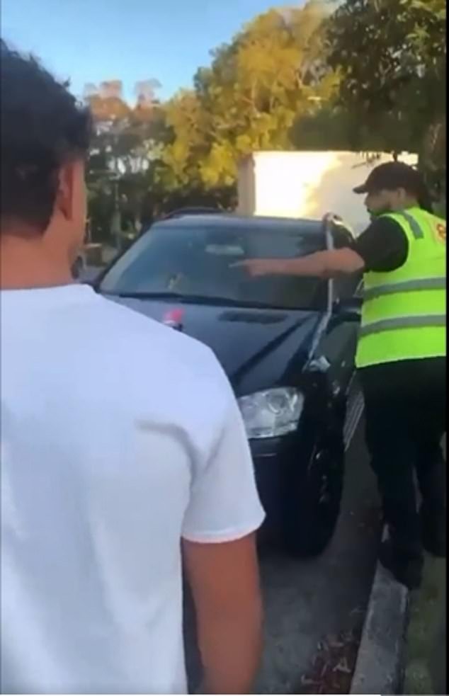 Footage of the confrontational incident shows the man (pictured) - who is wearing an orange vest, a black cap and appears to be of Middle Eastern origin - marching up to three teenage boys who appeared to be about to tie a The Israeli flag on their car in Bellevue Hill, in Sydney's eastern suburbs