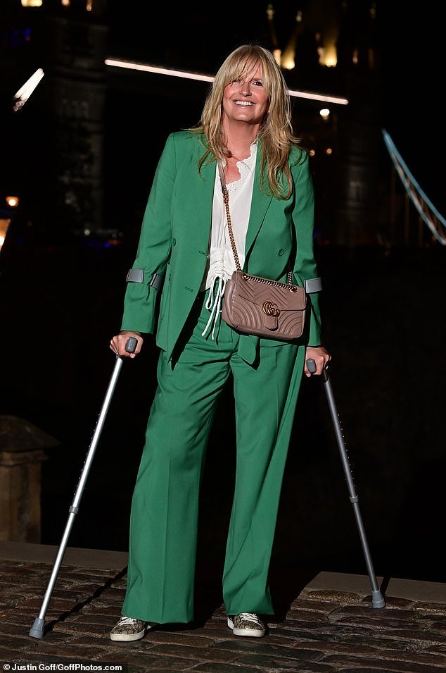Gorgeous: Penny Lancaster, 52, looked effortlessly stylish on Tuesday as she arrived on crutches for Gary Horner's book launch at the Tower of London