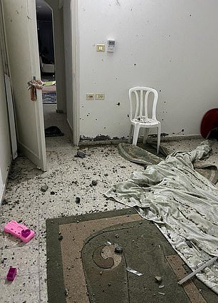 The parents and their two young children were visiting family in the city (pictured, bomb damage to the family's home)