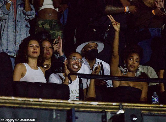 Fun times: The Golden Globe winner was in good company in the stands as she danced alongside Kelly Rowland (right)