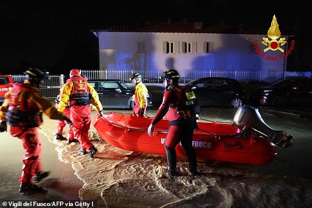 This photo was taken and distributed on November 3, 2023 by the Vigili del Fuoco, the Italian Corps.  of firefighters, shows Italian firefighters working to evacuate people from flooded houses in Campi Bisenzio, near Florence, after the Ciaran storm hit Tuscany, late November 2, 2023