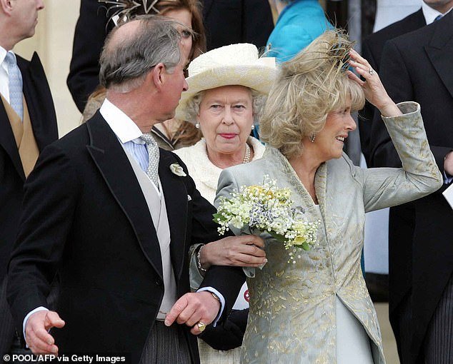 Prince Charles talks to his mother as he walks away from St. George's Chapel with his bride