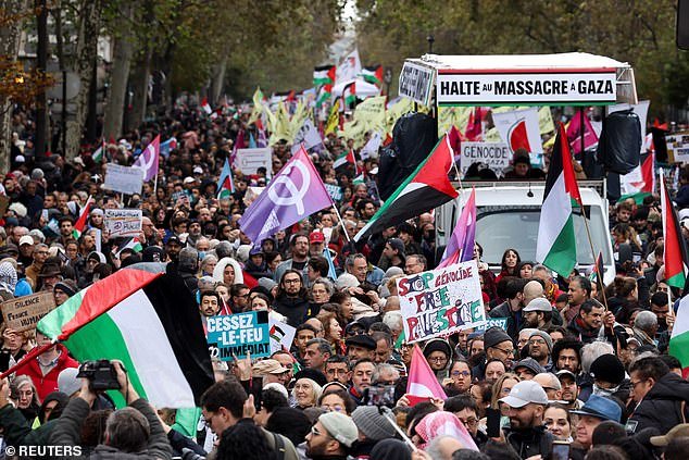 Pro-Palestinian activists march through the streets of Paris today calling for a ceasefire in Gaza