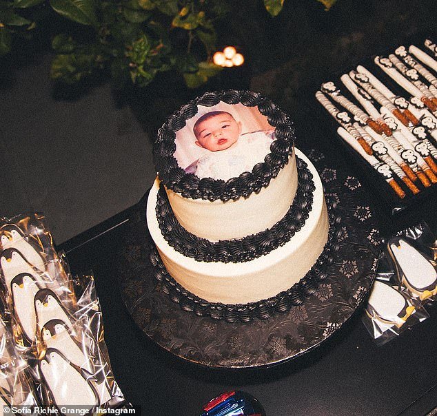 Baby photo: The last photo in the series is a photo of the tiered cake with a baby photo of Elliot on it