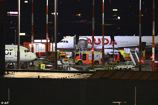 Fire vehicles arrive at a security scene at Hamburg Airport.  Flights have been cancelled
