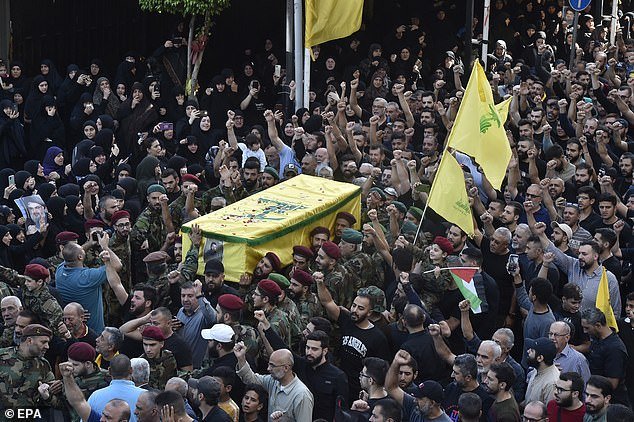 The coffin of Hezbollah fighter Ali Rmeity, killed in southern Lebanon on Friday, is carried at his funeral