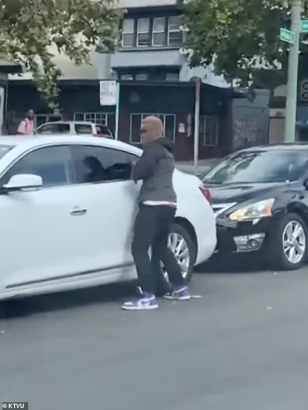 A robber is seen carjacking a vehicle on the streets of Oakland.  The total number of armed robberies in Oakland this year has reached 1,282, marking a 43 percent increase since this time last year
