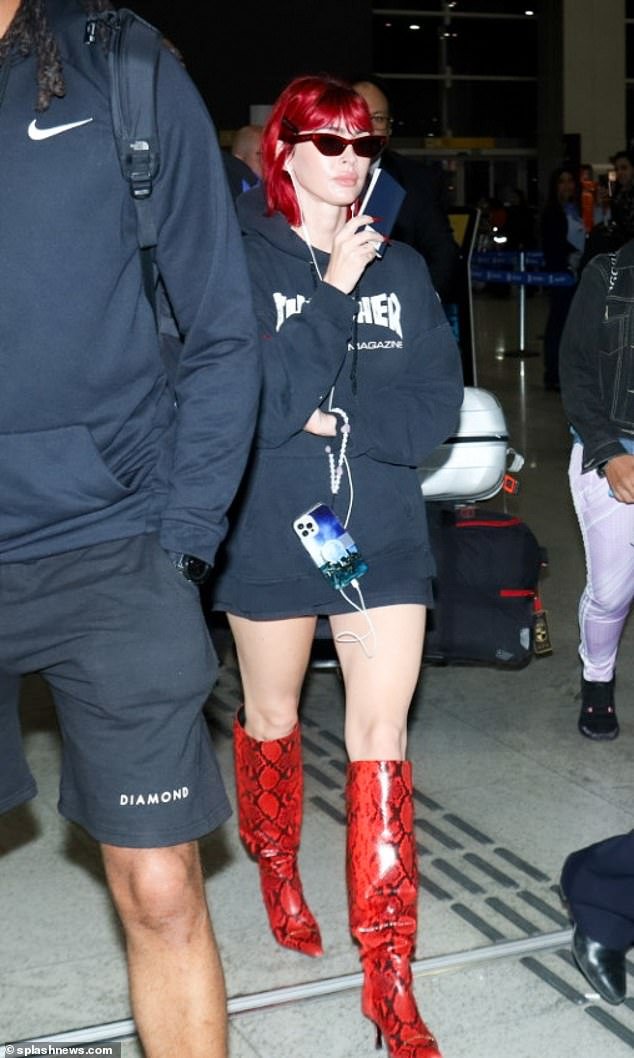 Gorgeous: She paired her freshly dyed bright red locks with a pair of snakeskin boots