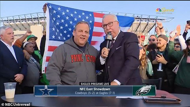 Earlier in the day, Christie stood for an interview with a reporter during a televised pre-game show, with the same flag prominently displayed in the background.