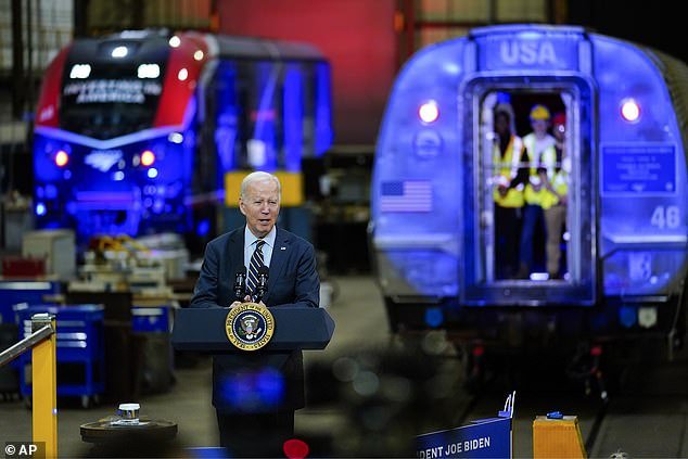 Biden delivered his address from the front of trains at the Amtrak repair shop